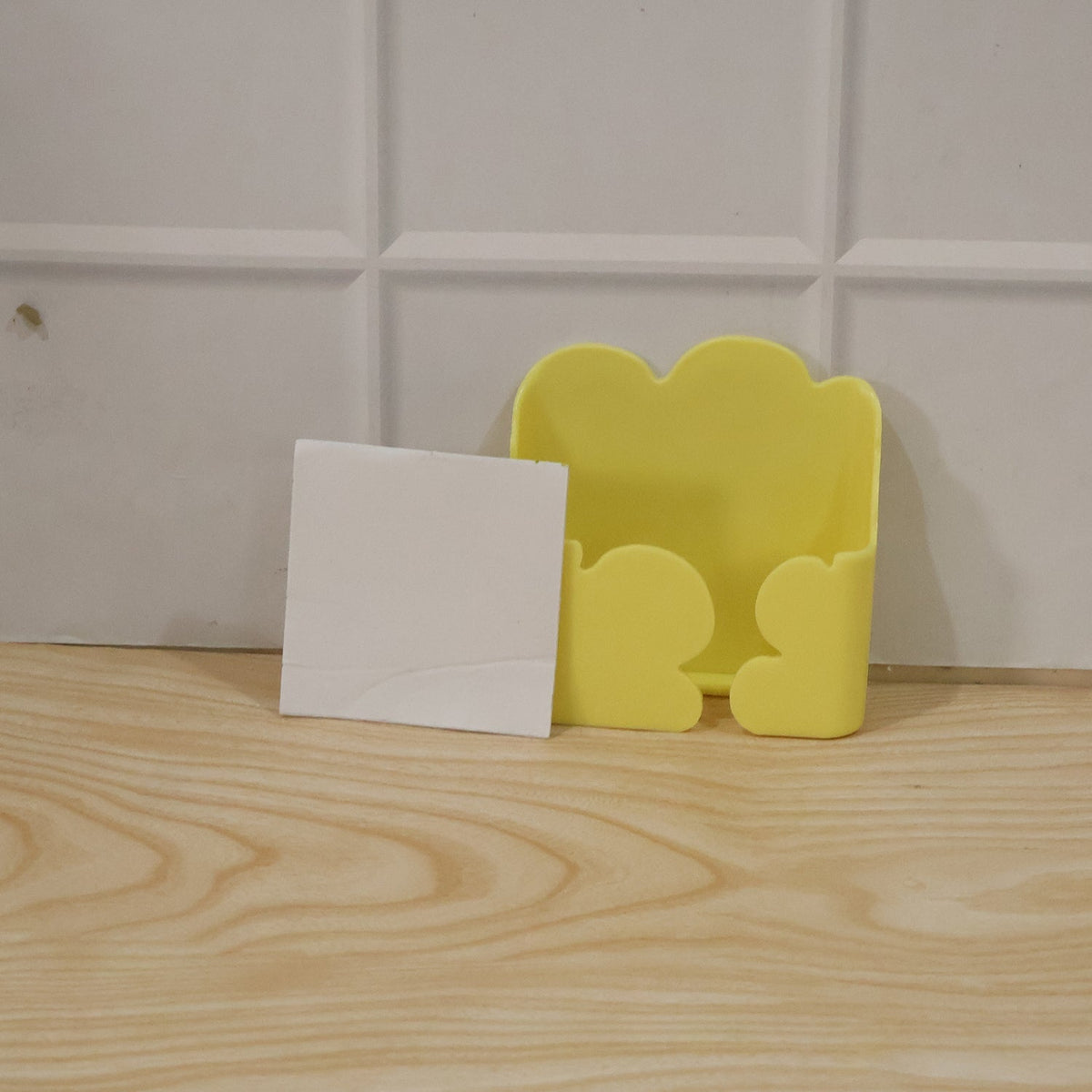 Product packaging highlighting key features of the wall mount holder.