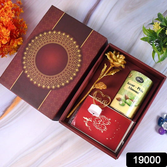 Valentineâs Day gift box with heart-shaped light, chocolates, and golden flower